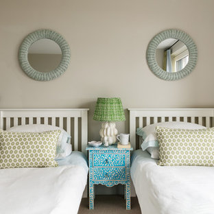 Inspiration for a medium sized coastal guest bedroom in London with beige walls, carpet and beige floors.