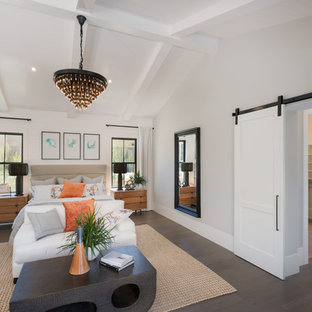 This is an example of a large transitional master bedroom in Phoenix with beige walls, dark hardwood floors, no fireplace and brown floor.