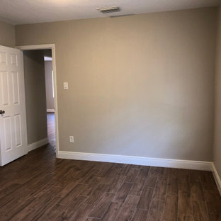 Small arts and crafts master bedroom in Orlando with beige walls, ceramic floors and brown floor.