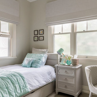 This is an example of a small transitional guest bedroom in Brisbane with beige walls, carpet and brown floor.