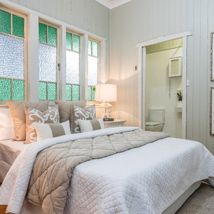 Inspiration for a country bedroom in Brisbane with grey walls, medium hardwood floors and brown floor.