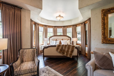 Photo of a traditional guest bedroom in Denver with beige walls and brown floors.