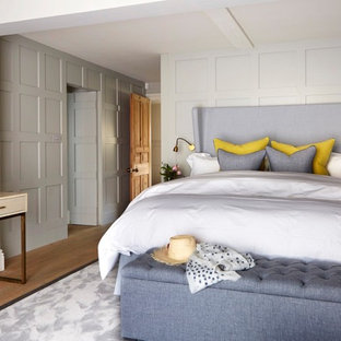Medium sized classic bedroom in Sussex with beige walls, medium hardwood flooring and brown floors.