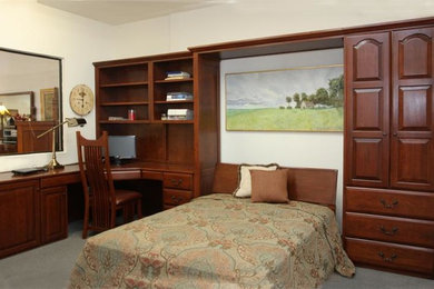 Example of a mid-sized classic guest carpeted and beige floor bedroom design in Los Angeles with white walls