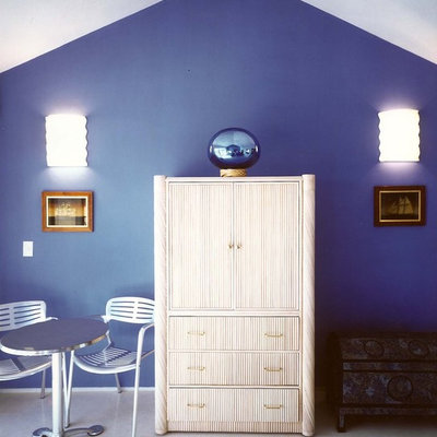 Example of an island style bedroom design in Other with blue walls