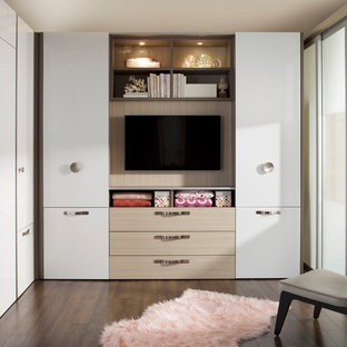 Inspiration for a small modern loft-style dark wood floor bedroom remodel in New York with white walls and no fireplace