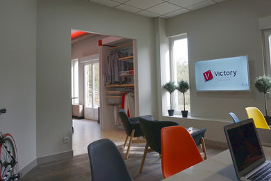 Aménagement d'un bureau contemporain de taille moyenne avec un mur blanc, un sol en bois brun, un bureau indépendant et un sol marron.