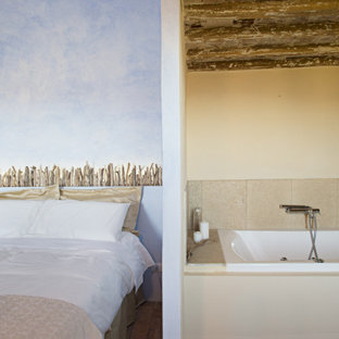 Foto de dormitorio principal, bohemio, de tamaño medio, con suelo rojo, paredes azules y suelo de baldosas de terracota