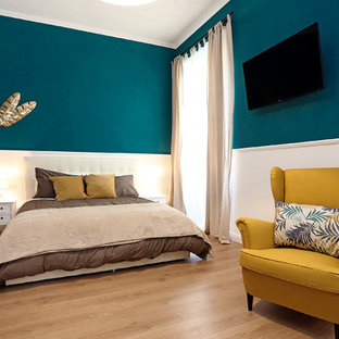 Ejemplo de dormitorio principal, tradicional, grande, sin chimenea, con paredes azules y suelo laminado