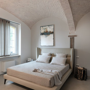 Esempio di una camera da letto mediterranea con pareti grigie e pavimento grigio