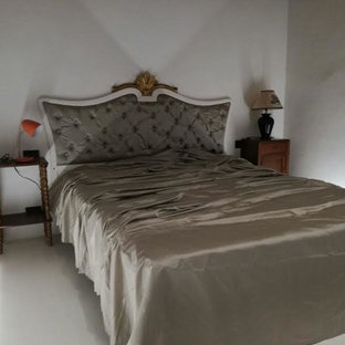 Foto de dormitorio principal, clásico, de tamaño medio, con paredes blancas y suelo de ladrillo