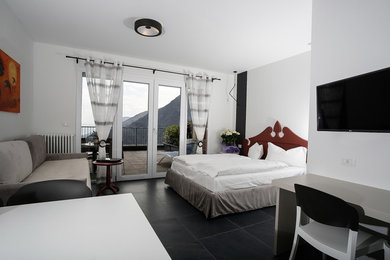 Inspiration for a contemporary guest porcelain tile and gray floor bedroom remodel in Other with multicolored walls