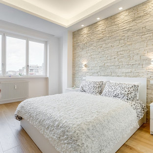 Esempio di una camera da letto minimal con pareti bianche, parquet chiaro e pavimento beige