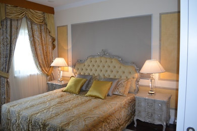 Modelo de dormitorio principal clásico de tamaño medio con paredes multicolor, suelo de madera oscura y suelo marrón