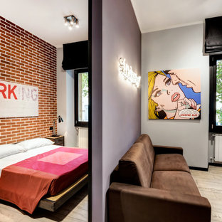 Imagen de dormitorio tipo loft, urbano, pequeño, con paredes rojas y suelo de baldosas de porcelana