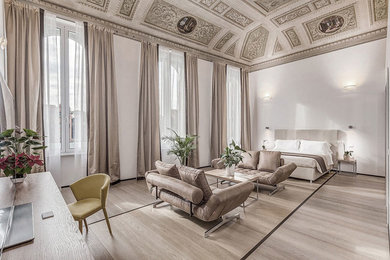 Foto de dormitorio principal clásico grande con paredes blancas, suelo de madera clara y suelo beige