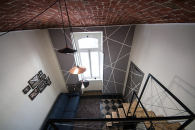 Idee per una camera degli ospiti design di medie dimensioni con pareti bianche, pavimento in cemento e pavimento multicolore