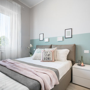 Ispirazione per una piccola camera matrimoniale nordica con pareti beige, parquet chiaro e pavimento beige