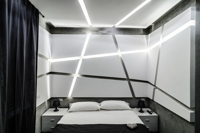 Immagine di una camera matrimoniale minimalista di medie dimensioni con pareti bianche, pavimento in gres porcellanato e pavimento grigio
