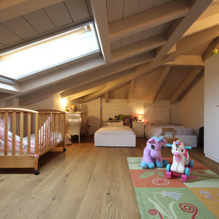 Lantlig inredning av ett stort pojkrum kombinerat med sovrum och för 4-10-åringar, med beige väggar, mellanmörkt trägolv och brunt golv
