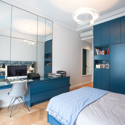 Inspiration for a large contemporary boy medium tone wood floor kids' room remodel in Paris with white walls
