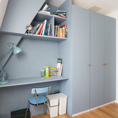Inspiration for a mid-sized contemporary boy beige floor and medium tone wood floor kids' room remodel in London with blue walls