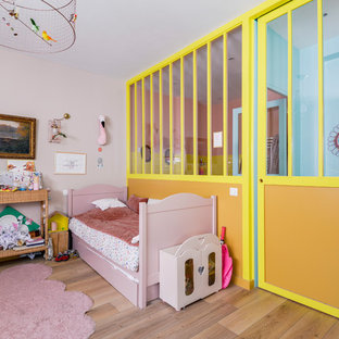 Inspiration pour une chambre d'enfant bohème avec un mur rose et un sol marron.