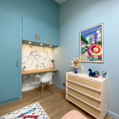 Example of a mid-sized trendy girl medium tone wood floor and beige floor kids' room design in Bordeaux with blue walls