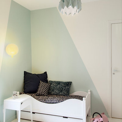Trendy gender-neutral white floor kids' room photo in Paris with blue walls