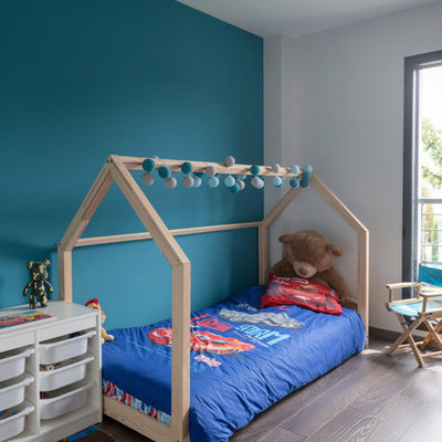 Trendy boy dark wood floor and brown floor kids' room photo in Lyon with white walls