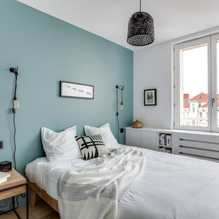 Imagen de dormitorio principal, nórdico, pequeño, con paredes azules y suelo de madera clara