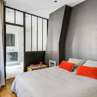 Idées déco pour une chambre parentale contemporaine avec un mur gris, un sol en bois brun et un sol marron.