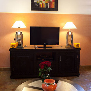 This is an example of a large mediterranean master bedroom in Other with beige walls, terra-cotta floors and no fireplace.