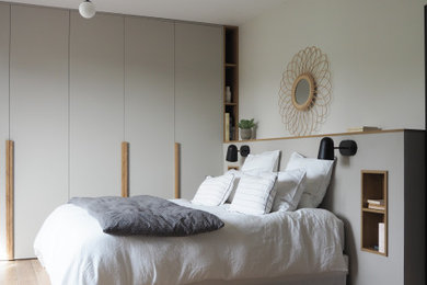 他の地域にある中くらいなコンテンポラリースタイルのおしゃれな主寝室 (白い壁、無垢フローリング、ベージュの床) のレイアウト