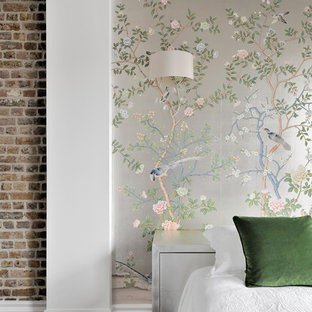This is an example of a bohemian bedroom in London with multi-coloured walls and dark hardwood flooring.