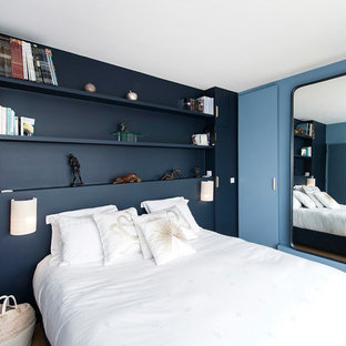 Foto de dormitorio principal, actual, de tamaño medio, sin chimenea, con paredes azules, suelo de madera clara y suelo beige