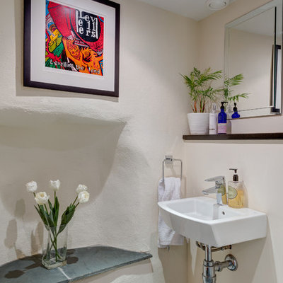 Inspiration for a small mediterranean slate floor powder room remodel in Devon with a wall-mount sink and white walls