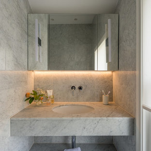 Design ideas for a contemporary cloakroom in London with grey tiles, a submerged sink, marble worktops and white worktops.
