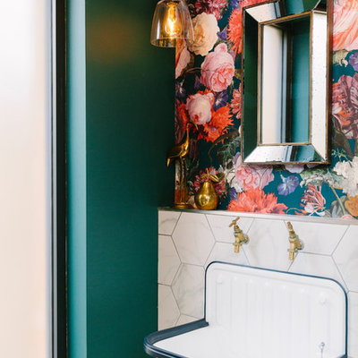 Example of a small transitional powder room design in London with multicolored walls, a wall-mount sink and a one-piece toilet