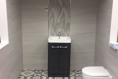 Photo of a contemporary cloakroom in Essex with grey tiles, ceramic tiles, grey walls and porcelain flooring.