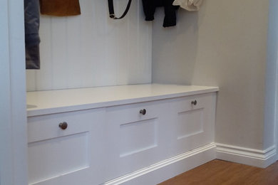 Design ideas for a small traditional cloakroom in Surrey with shaker cabinets, white cabinets and wooden worktops.