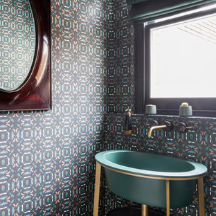 This is an example of a contemporary cloakroom in London with multi-coloured walls and a console sink.