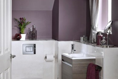 Inspiration for a small contemporary cloakroom in Other with flat-panel cabinets, light wood cabinets, a wall mounted toilet, white tiles, purple walls, porcelain flooring, a wall-mounted sink and white floors.