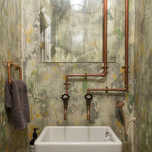 This is an example of an urban cloakroom in London with green walls, a vessel sink, wooden worktops and brown worktops.