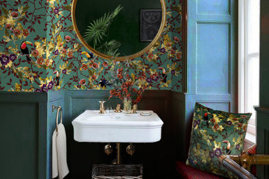 Photo of an eclectic cloakroom in London with green walls and wallpapered walls.