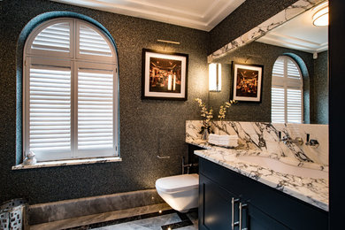 Design ideas for a classic cloakroom in Buckinghamshire with shaker cabinets, black cabinets, a wall mounted toilet, black walls, marble flooring, a submerged sink, grey floors and grey worktops.