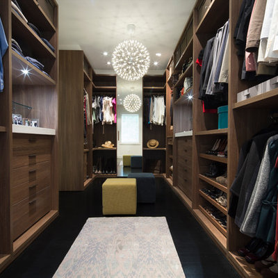 Dressing room - large contemporary gender-neutral dark wood floor and black floor dressing room idea in DC Metro with flat-panel cabinets and medium tone wood cabinets