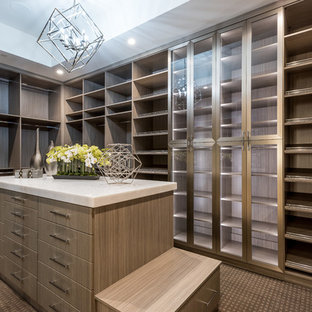 Example of a large trendy gender-neutral carpeted and brown floor dressing room design in Las Vegas with flat-panel cabinets and medium tone wood cabinets