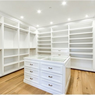 Huge country gender-neutral walk-in closet photo in Los Angeles with flat-panel cabinets and white cabinets