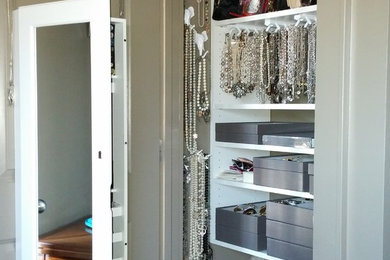 Example of an eclectic closet design in Columbus with open cabinets and white cabinets